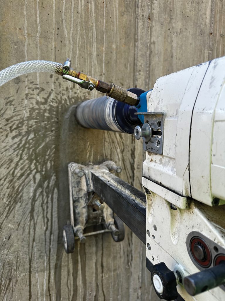 Core drilling equipment being used on a wall