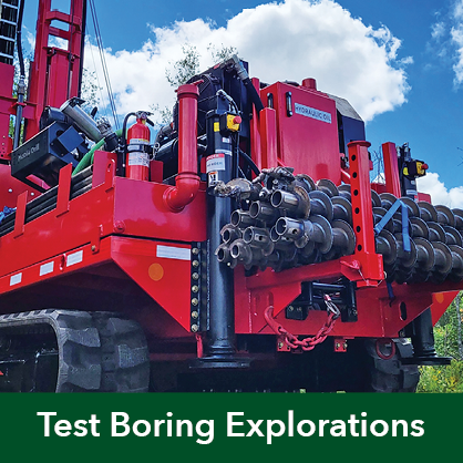 Photo of a red drilling rig parked in a parking lot.