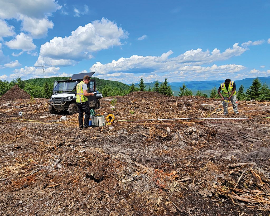 Two geotechnical engineers performing electrical resistivity testing.