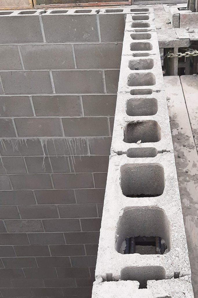 A photo from a construction site showing a structure built of concrete masonry units.