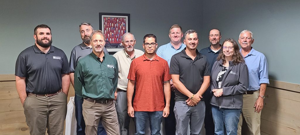 A group photo of the Stephen W. Cole Emerging Leaders class and mentors standing in an interior space.